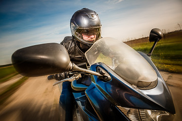 Image showing Biker racing on the road