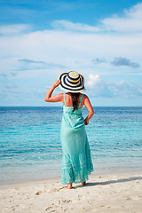 Image showing Girl walking along a tropical beach in the Maldives.