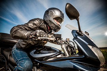 Image showing Biker racing on the road