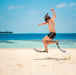 Image showing Funny man jumping in flippers and mask.