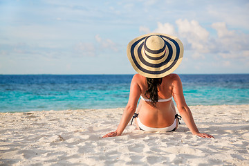 Image showing Girl walking along a tropical beach in the Maldives.