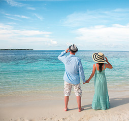 Image showing Vacation Couple walking on tropical beach Maldives.