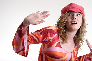 Image showing Startled woman in 70s attire