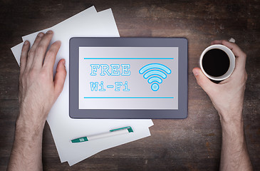 Image showing Tablet with Wi-Fi connection on a wooden desk