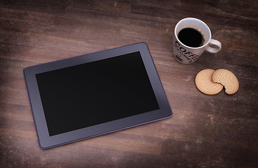 Image showing Tablet touch computer gadget on wooden table