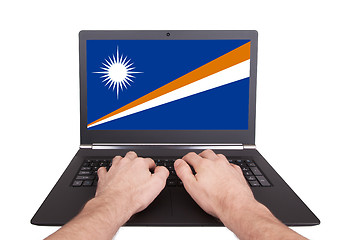 Image showing Hands working on laptop, Marshall Islands