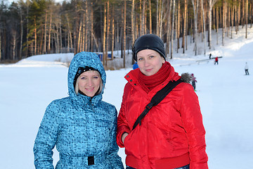 Image showing Portrait of two women in winter clothes in the winter outdoors.