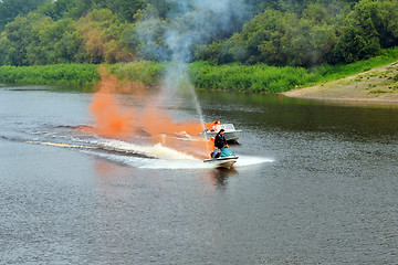 Image showing The man on a hydrocycle floats down the river.