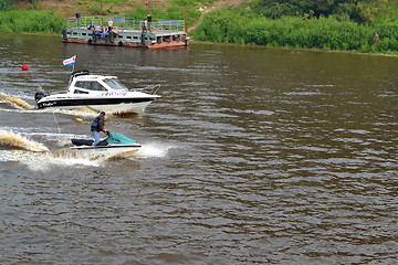 Image showing The man on a hydrocycle floats down the river.