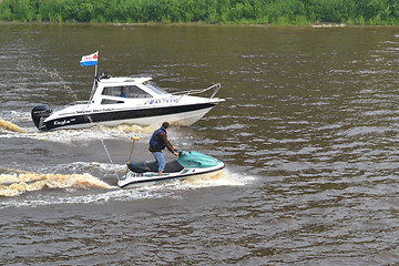 Image showing The man on a hydrocycle floats down the river