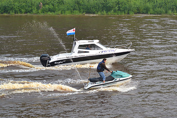 Image showing The man on a hydrocycle floats down the river.