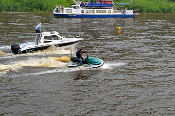 Image showing The man on a hydrocycle floats down the river.