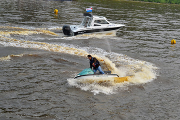 Image showing The man on a hydrocycle floats down the river.