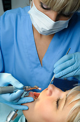 Image showing dentist with patient, polishing and finishing