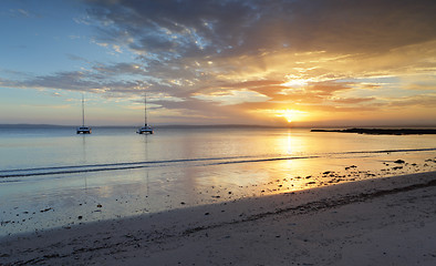 Image showing Catamarans on the water at sunset