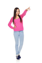 Image showing Casual woman pointing at blank copy space