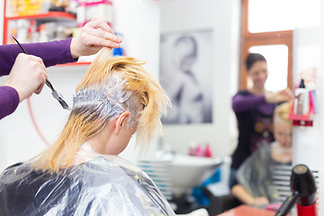 Image showing Hairdresser salon. Woman during hair dye. 