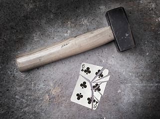 Image showing Hammer with a broken card, six of clubs