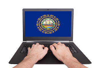 Image showing Hands working on laptop, New Hampshire