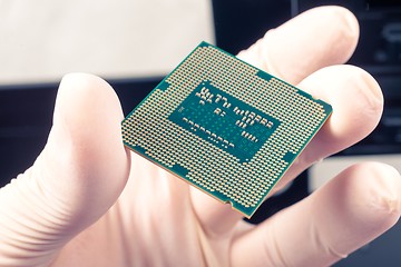 Image showing Human hand holding modern processor