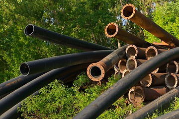 Image showing Rusty metal pipes in the forest