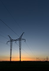 Image showing Large transmission towers at sunset