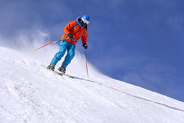 Image showing Skier skiing downhill