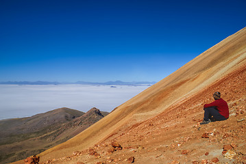 Image showing Hiker on colored mountain