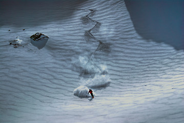 Image showing Male skier riding down the hill