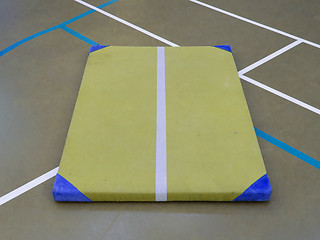 Image showing Very old yellow mat on a blue court