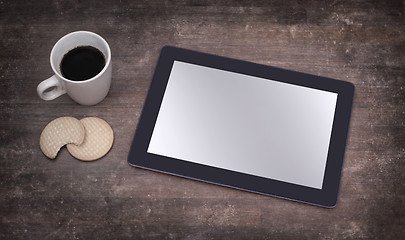 Image showing Tablet touch computer gadget on wooden table