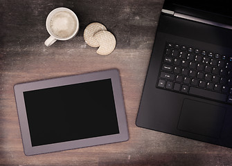 Image showing Tablet touch computer gadget on wooden table