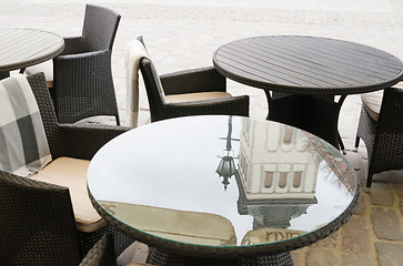 Image showing Reflection of the church spire on the surface of a table in a ca