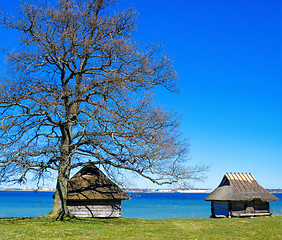 Image showing Old rural building with a roof covered by straw, close-up