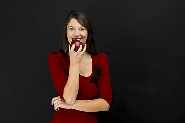 Image showing Young woman eating an apple