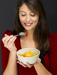 Image showing Woman eating a fruit salad