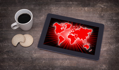 Image showing World map on a tablet