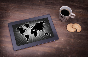 Image showing World map on a tablet