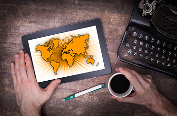 Image showing World map on a tablet