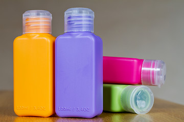 Image showing Small colored plastic bottles for traveling