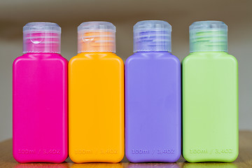 Image showing Small colored plastic bottles for traveling