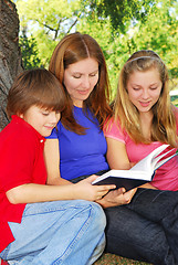 Image showing Family reading a book
