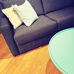 Image showing Sofa with cushions and green coffee table