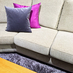 Image showing Sofa with purple cushions on a fluffy carpet