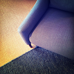 Image showing Blue textile armchair and knitted carpet