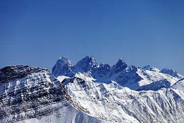 Image showing Snowy rocks at sun day