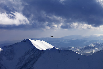 Image showing Off-piste slope for heliskiing and helicopter in evening