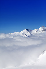 Image showing Mountains in clouds at nice winter day