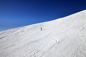 Image showing Skier on slope in sun day