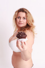 Image showing Woman with big breasts presents a muffin chocolate